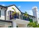 Second story balcony with seating and tropical plants under a bright blue sky at 570 Manor Rd, Maitland, FL 32751
