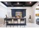 Stylish bar area with a marble countertop, dark cabinetry, and contemporary seating at 570 Manor Rd, Maitland, FL 32751