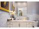 Elegant bathroom featuring marble countertops, patterned tile walls, and decorative accents at 570 Manor Rd, Maitland, FL 32751