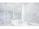 Bright bathroom with a soaking tub, glass shower, double vanity, and modern design at 570 Manor Rd, Maitland, FL 32751