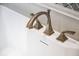 Close-up of a white bathtub with modern bronze fixtures and a marble tile backsplash at 570 Manor Rd, Maitland, FL 32751