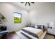 Bright bedroom with hardwood floors, a large window view, and a comfortable queen-sized bed at 570 Manor Rd, Maitland, FL 32751