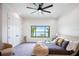 Bedroom with neutral decor, a large window showcasing waterfront views, and a cozy chair at 570 Manor Rd, Maitland, FL 32751