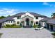 Luxurious home with stone accents, a paved driveway, professional landscaping, and a car parked in the front at 570 Manor Rd, Maitland, FL 32751