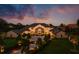 Luxury home exterior showcasing professional landscaping, an arched entryway, and paved driveway during sunset at 570 Manor Rd, Maitland, FL 32751