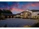 Two-story home with a stone archway entrance, a circular driveway, lush landscaping, and a three car garage at 570 Manor Rd, Maitland, FL 32751