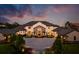 Stunning two-story home with a stone facade, manicured lawn, mature trees, and a circular driveway at 570 Manor Rd, Maitland, FL 32751