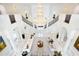 Grand foyer showcasing a stunning chandelier, a double staircase, and elegant white marble flooring at 570 Manor Rd, Maitland, FL 32751