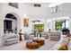 Spacious living room featuring high ceilings, large windows, and stylish decor throughout with a bar area in the background at 570 Manor Rd, Maitland, FL 32751