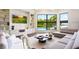 Bright living room with pool view, white shelving, large windows and comfortable seating at 570 Manor Rd, Maitland, FL 32751