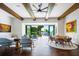 Stunning living room with natural light, wood beams, and access to the outdoor pool and backyard at 570 Manor Rd, Maitland, FL 32751