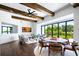 Bright living room featuring wood beams, hardwood floors, and sliding glass doors to the backyard at 570 Manor Rd, Maitland, FL 32751
