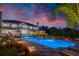 Stunning backyard with a large pool, lush landscaping, and an expansive luxury two-story home during twilight at 570 Manor Rd, Maitland, FL 32751