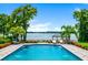 Beautiful pool overlooks lakefront with gazebo and well manicured landscaping around pool deck at 570 Manor Rd, Maitland, FL 32751