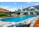Backyard pool area with a spa, stone patio, and lush landscaping offering an ideal outdoor retreat at 570 Manor Rd, Maitland, FL 32751