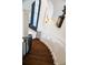 Elegant dark wood staircase with decorative wrought iron railing and stylish wall sconces at 570 Manor Rd, Maitland, FL 32751