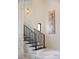 Modern staircase featuring sleek black railings, contemporary art, and elegant lighting at 570 Manor Rd, Maitland, FL 32751