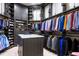 Sophisticated walk-in closet featuring dark wood finishes, custom shelving, and marble countertops at 570 Manor Rd, Maitland, FL 32751