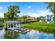 Beautiful property including boat dock, jet skis, lush grass, landscaping, and the home in the background at 570 Manor Rd, Maitland, FL 32751
