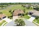 Aerial view of home with brick paved driveway in landscaped community at 5799 Linen Bluff Pl, Leesburg, FL 34748