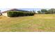 Large backyard with expansive green lawn and view of the screened in pool at 5799 Linen Bluff Pl, Leesburg, FL 34748