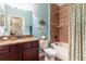 Inviting bathroom with granite vanity, decorative accents, and a tiled shower-tub combo at 5799 Linen Bluff Pl, Leesburg, FL 34748