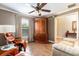 Relaxing living area with recliner, armoire, and hardwood floors, creating a cozy and inviting atmosphere at 5799 Linen Bluff Pl, Leesburg, FL 34748