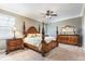 Main bedroom with carpet, a decorative ceiling fan, and luxurious furnishings at 5799 Linen Bluff Pl, Leesburg, FL 34748