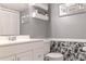 Tasteful bathroom showcasing a vanity with storage and elegant tropical-themed decor at 5961 Windhover Dr # F05, Orlando, FL 32819