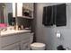 Well-lit bathroom highlighting a modern vanity, storage cabinet, and towel rack at 5961 Windhover Dr # F05, Orlando, FL 32819