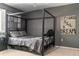 Stylish bedroom showcasing a statement canopy bed and tasteful wall art at 5961 Windhover Dr # F05, Orlando, FL 32819