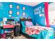 Bright, fun bedroom featuring colorful decor and a playful accent wall at 5961 Windhover Dr # F05, Orlando, FL 32819