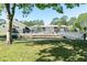 Community featuring a pool, scenic pond, and walking bridge at 5961 Windhover Dr # F05, Orlando, FL 32819