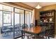 Cozy dining room with access to a screened-in patio and outdoor seating at 5961 Windhover Dr # F05, Orlando, FL 32819