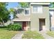 Charming two-story townhome featuring a textured exterior and cozy front porch at 5961 Windhover Dr # F05, Orlando, FL 32819