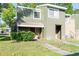 Charming two-story townhome featuring a textured exterior and cozy front porch at 5961 Windhover Dr # F05, Orlando, FL 32819