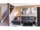 Inviting living room featuring comfortable seating, modern decor, and easy access to stairs at 5961 Windhover Dr # F05, Orlando, FL 32819