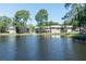 Beautiful waterfront view of a complex with a picturesque pond featuring a fountain and lush landscaping at 5961 Windhover Dr # F05, Orlando, FL 32819