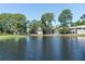 Scenic complex pond view with mature trees and landscaping creating a serene atmosphere for residents at 5961 Windhover Dr # F05, Orlando, FL 32819