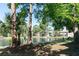 Scenic view of community pond with fountain, lush greenery, and inviting walking path at 5961 Windhover Dr # F05, Orlando, FL 32819