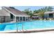 Inviting community pool area with lounge chairs and clear blue water, perfect for relaxation and recreation at 5961 Windhover Dr # F05, Orlando, FL 32819