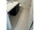 Clean bathroom featuring a vanity with dark cabinets and a white countertop, complemented by light tile flooring at 604 Sarner Pass Way, Winter Haven, FL 33881