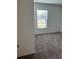 Cozy bedroom featuring neutral carpet, a window with blinds, and freshly painted walls at 604 Sarner Pass Way, Winter Haven, FL 33881