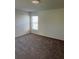 Cozy bedroom with plush carpeting and a large window at 604 Sarner Pass Way, Winter Haven, FL 33881