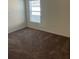 A carpeted bedroom with a window providing natural light, offering a clean, blank canvas at 604 Sarner Pass Way, Winter Haven, FL 33881