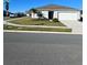Well-maintained single-story home with attached garage and manicured front lawn on a sunny day at 604 Sarner Pass Way, Winter Haven, FL 33881