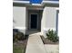 Inviting front entrance with a walkway leading to a stylish, dark-colored front door at 604 Sarner Pass Way, Winter Haven, FL 33881