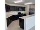Modern kitchen with sleek cabinets, stainless steel appliances, and quartz countertops at 604 Sarner Pass Way, Winter Haven, FL 33881