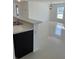 Open-concept living space featuring tile floors, modern lighting, and a breakfast bar at 604 Sarner Pass Way, Winter Haven, FL 33881