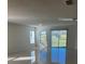 Open living room with tile floors, large windows, and sliding glass doors at 604 Sarner Pass Way, Winter Haven, FL 33881
